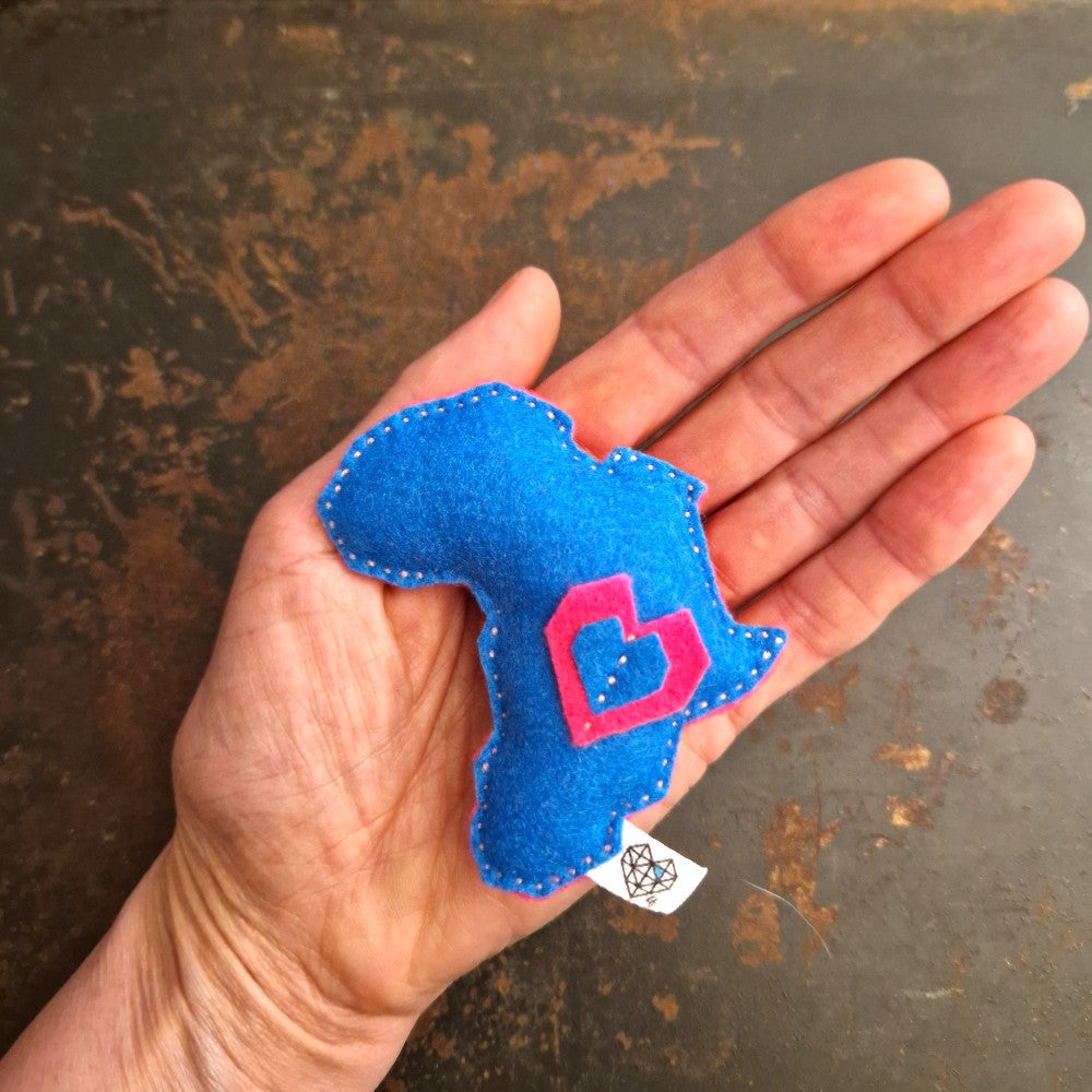 Yellow felt Africa-shaped magnet with a blue and yellow layered heart symbol.
