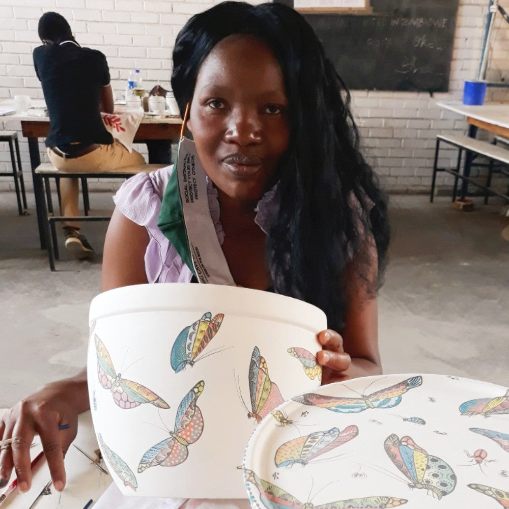 An artist from Hippo Studio with her hand-painted Papillon ceramics.