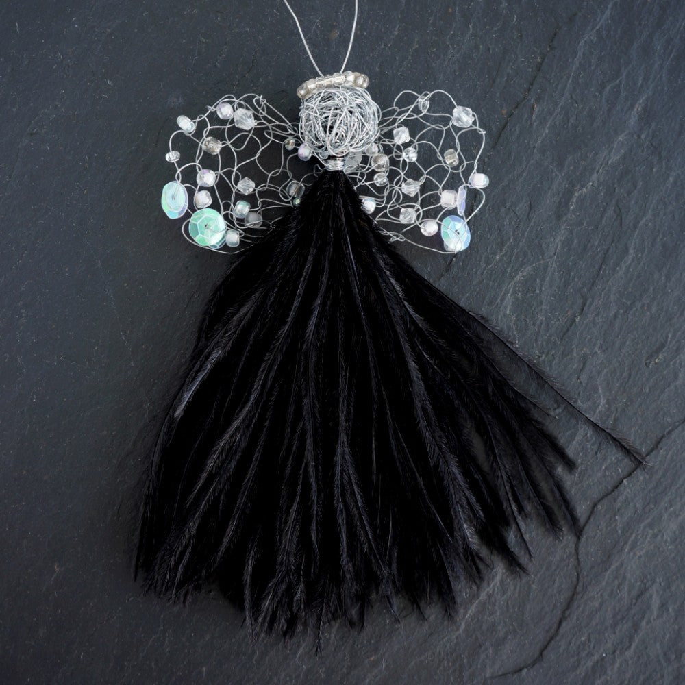 Angel Janine  has a black feather dress, wire head with beaded halo and crocheted wings.