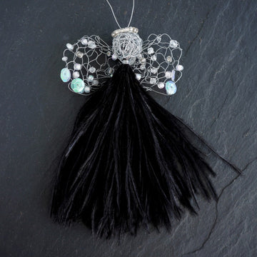 Angel Janine  has a black feather dress, wire head with beaded halo and crocheted wings.